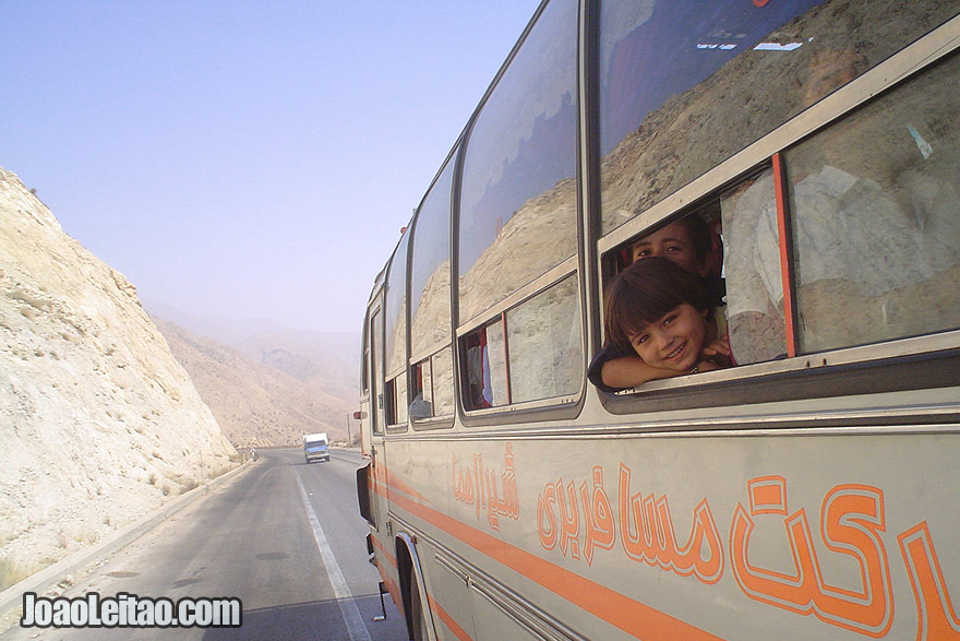 Photo of Iranian children looking through the window in bus from Bandar-e Abbas to Shiraz, Zagros Mountains, Iran - Middle East
